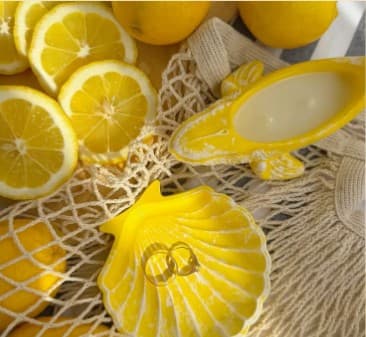 Lemons and yellow shell dish styled flat lay