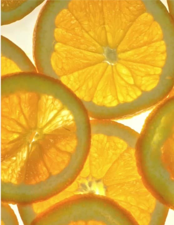 Close-up of sliced oranges backlit in sunlight