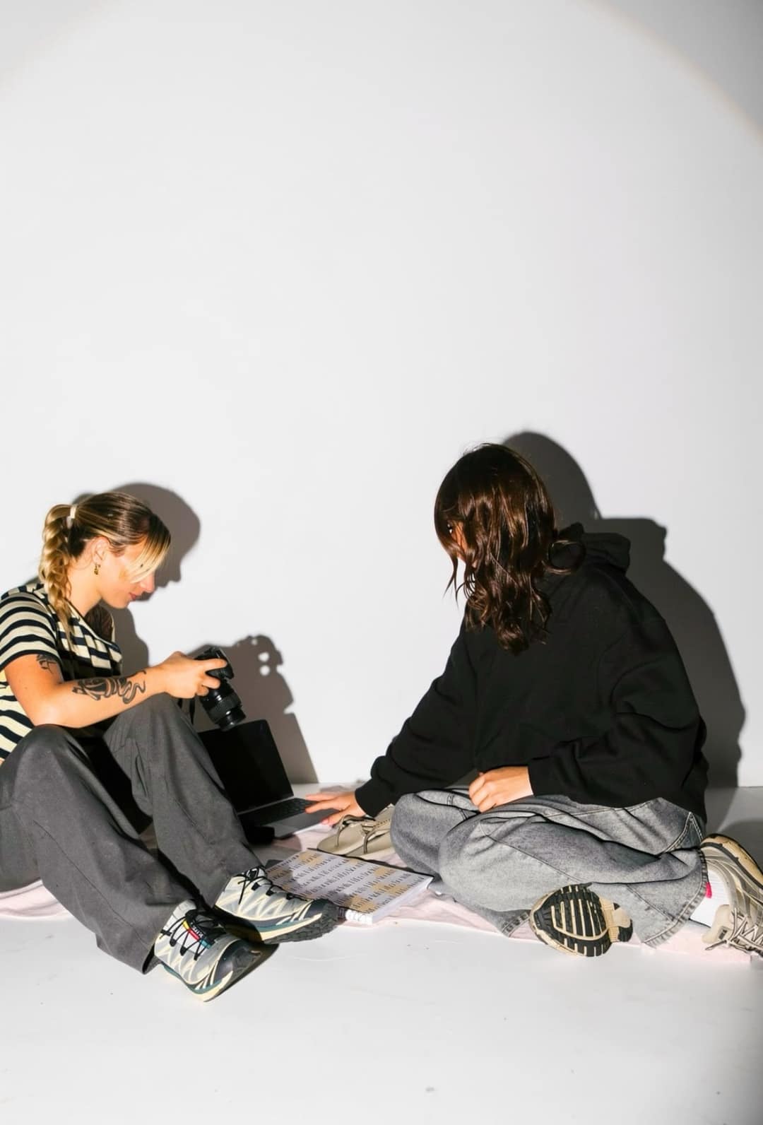 Reviewing content together, camera and laptop in hand